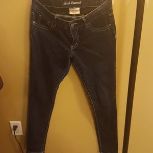 Dark wash skinny jeans with embellished pockets